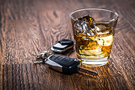Car keys next to alcohol, drunk driving accidents
