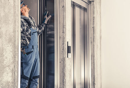 worker inspecting elevator