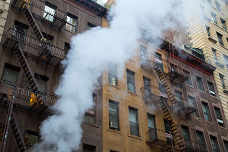 smoke and fire in NYC building, fire safety issues and code violations