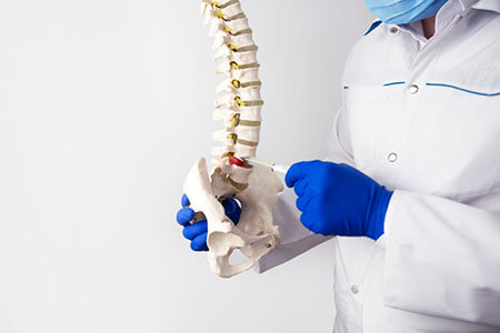 Doctor Showing Herniated Disc on Spine, Auto Accident Injuries