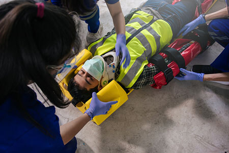 paramedics helping injured person, pain and suffering in personal injury cases