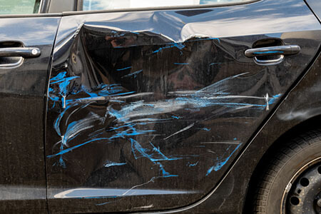 Side damage on black car, t-bone crash liability